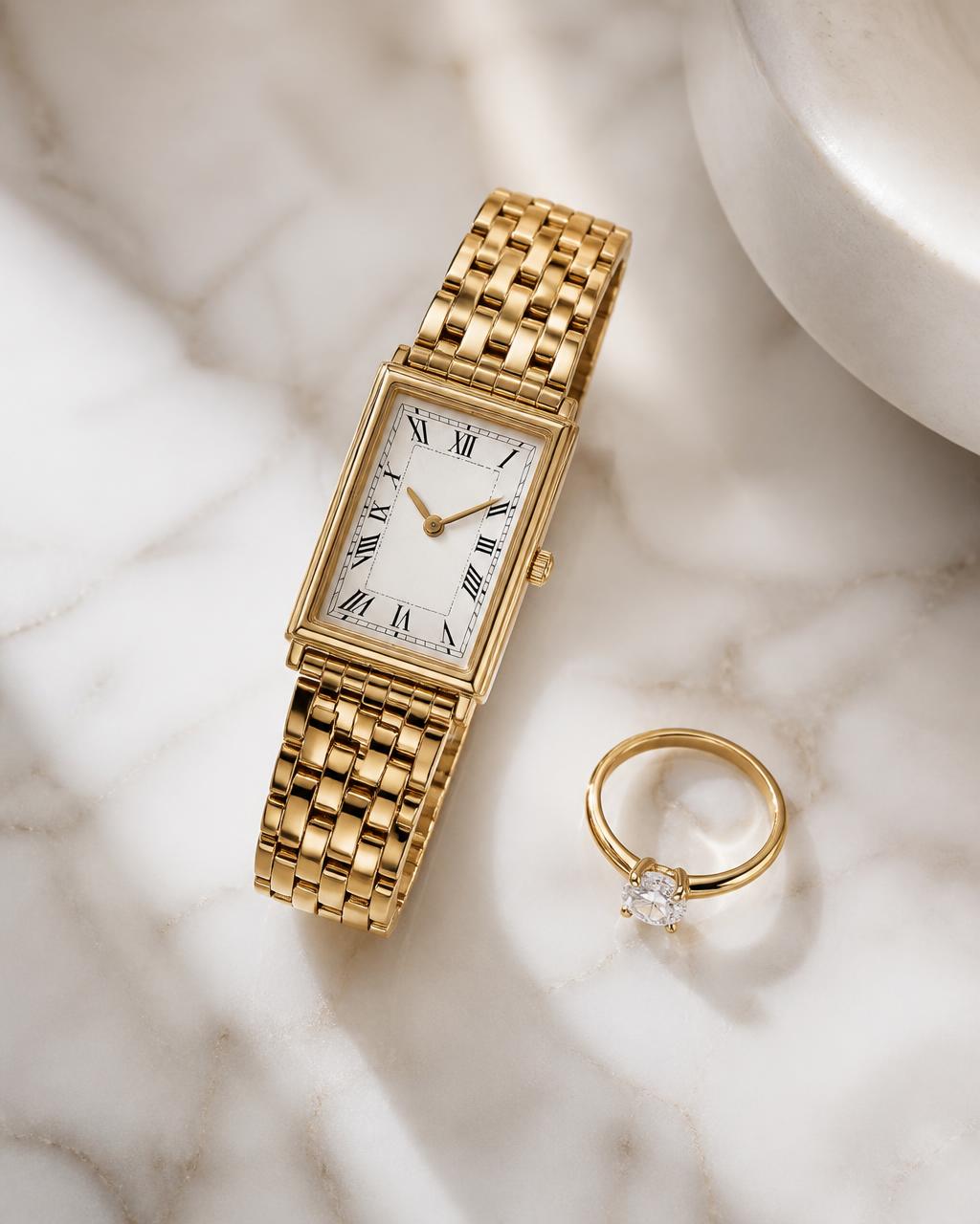 A Jean Paule watch and ring resting on a pale stone surface